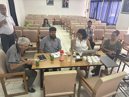 A group of people sitting around a table

AI-generated content may be incorrect.
